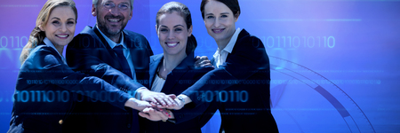 Portrait of happy business people huddling hands against white background against composite image of compassの写真素材