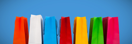 Shopping bags against blue backgroundの写真素材
