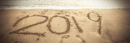 2019 written in the sand with waves coming inの写真素材