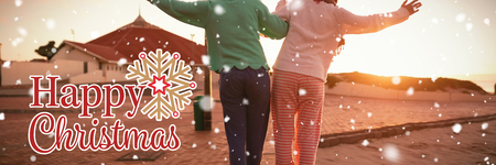 Christmas card against two women walking holding each otherの写真素材