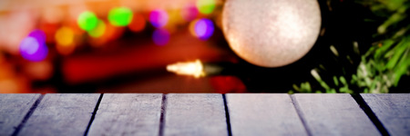 Snow falling against decorations on christmas tree
