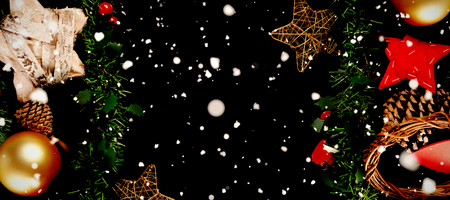 Snow falling against christmas decoration and ornamentの写真素材