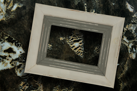 Empty photo frame against modern marble surfaceの写真素材