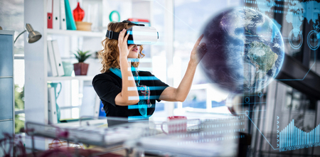 Earth globe against female designer wearing virtual reality headsetの写真素材