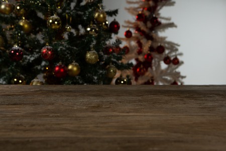 Wooden table in Christmas tree in background