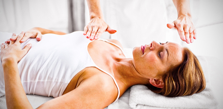 Woman receiving reiki treatment at spaの写真素材