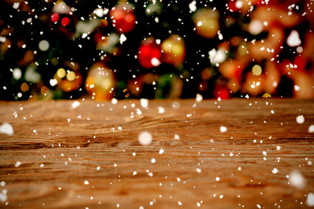 Snow falling against unfocused christmas tree with copy spaceの写真素材
