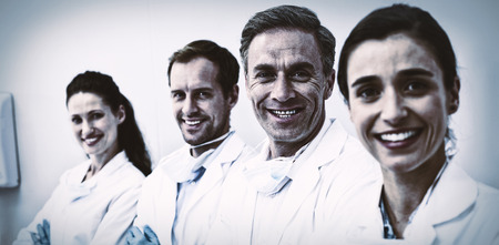 Portrait of smiling dentists standing with arms crossed in dental clinicの写真素材