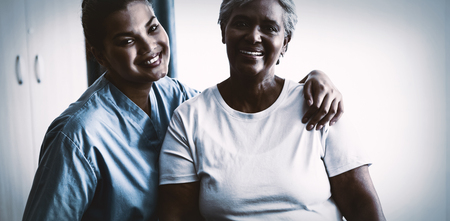 Portrait of young nurse with senior patient in nursing homeの写真素材