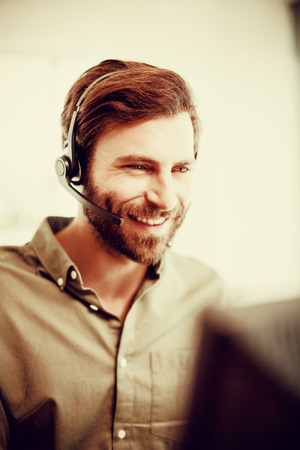 Smiling customer service executive working in call centerの写真素材