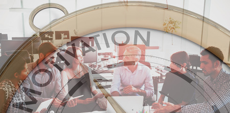 Compass pointing to motivation against business people interacting with each other in meetingの写真素材