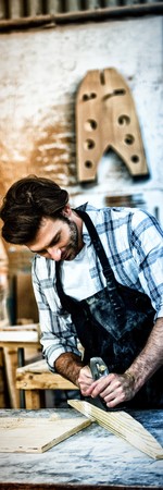 Carpenter working on his craft in a dusty workshop