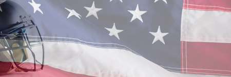 Sports helmet against white background against close-up of an american flag