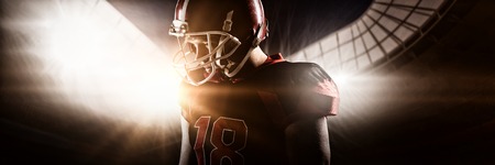 Young American football player standing in helmetの写真素材