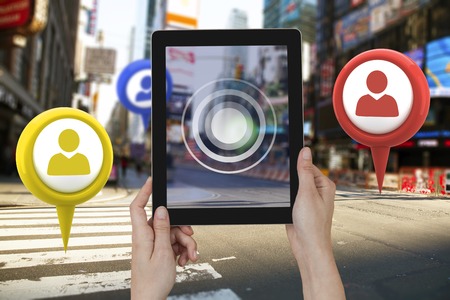 Hands holding digital tablet against white background against blurry new york streetの写真素材