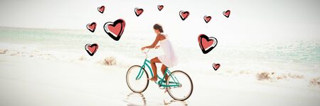 Red Hearts against  carefree woman going on a bike ride Carefree woman going on a bike ride on the beachの写真素材