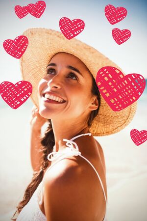 Red Hearts against happy woman posing on the beachの写真素材