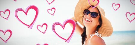Red Hearts against  portrait of smiling woman on the beach Portrait of smiling woman on the beach on a sunny dayの写真素材