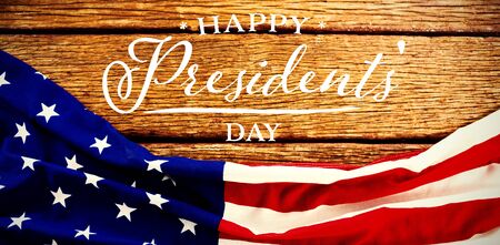 Happy presidents day. Vector typography against american flag on a brown tableの写真素材
