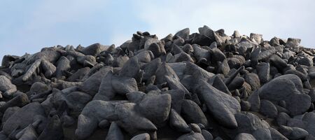 pile of rocks against scenic view of blue skyの写真素材