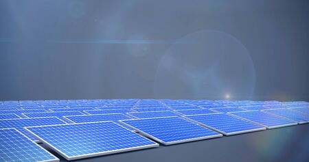 Blue solar panels against dark grey backgroundの写真素材