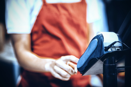 Female staff using credit card terminal at cash counter, Close-upの写真素材