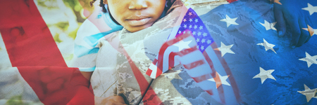 Close-up of crumbled American flag against happy family posing togetherの写真素材