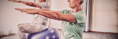 Seniors using exercise ball in studioの写真素材
