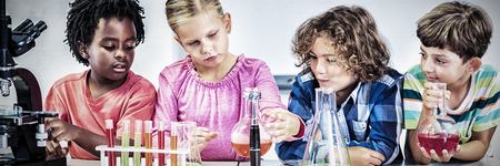 Kids doing a chemical experiment in laboratory at schoolの写真素材