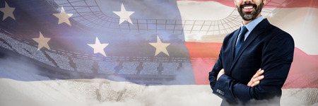 Portrait of smiling confident businessman against close-up of an american flag