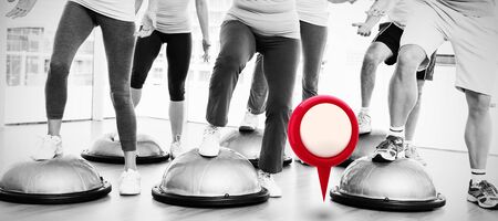 Close-up of map marker against low section of people doing power fitness exerciseの写真素材