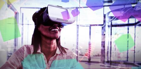 Composite image of face against female executive using virtual reality headset