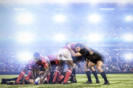 Rugby player scrum against digital image of crowded soccer stadiumの写真素材
