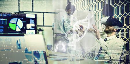 Illustration of DNA against businessman using virtual reality headset while colleagues discussing over flip chartの写真素材