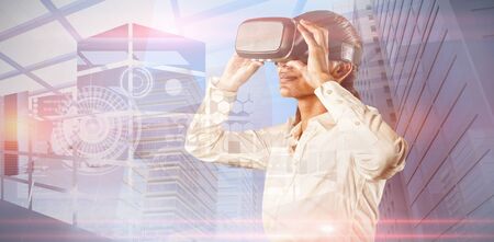 Female use virtual reality headset against composite image of interface on abstract screenの写真素材
