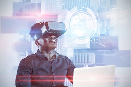 Happy man using VR headset against composite image of technology interface