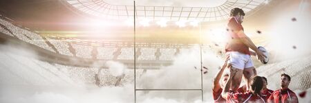 Male rugby players playing rugby in the ground against rugby posts in the fogの写真素材