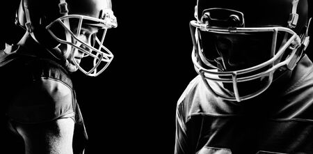 Young American football player standing in helmetの写真素材