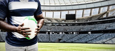 Strong Rugby Player against rugby goal post on a sunny day in the stadiumの写真素材