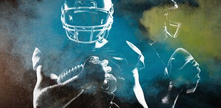 Rear view of American football player in helmet pointing upwardsの写真素材