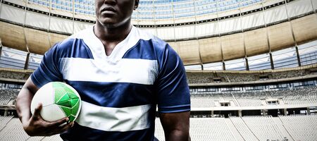 Strong Rugby Player against rugby goal post on a sunny day in the stadiumの写真素材