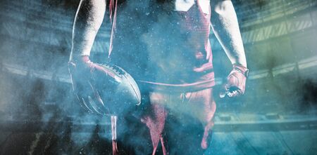 American Football Player against splashing of yellow color powderの写真素材