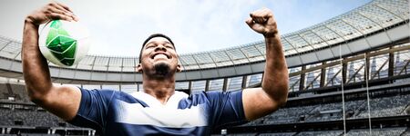 Strong Rugby Player against rugby stadium on a sunny day