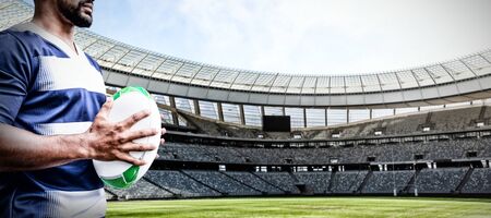 Strong Rugby Player against rugby stadium on a sunny dayの写真素材