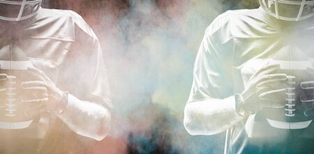 American football player standing with helmet, Close-upの写真素材