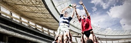 Rugby Players Playing Match against rugby stadium in the morningの写真素材