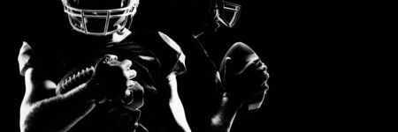 Rear view of American football player in helmet pointing upwardsの写真素材
