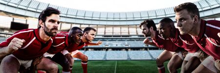 Diverse rugby players on field against rugby stadium at dawnの写真素材