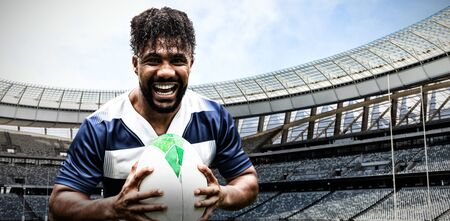 Strong Rugby Player against rugby stadium on a sunny dayの写真素材