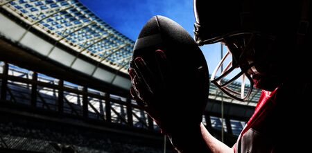 American Football Player against rugby stadium on a sunny day